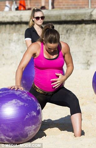 Michelle Bridges does sit-ups on a fitball at seven months... as she leads world record attempt ...