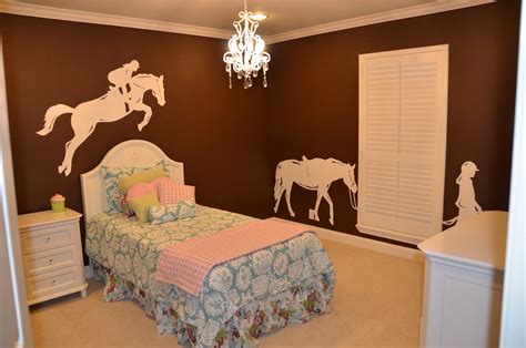 a bedroom with horse decals on the wall