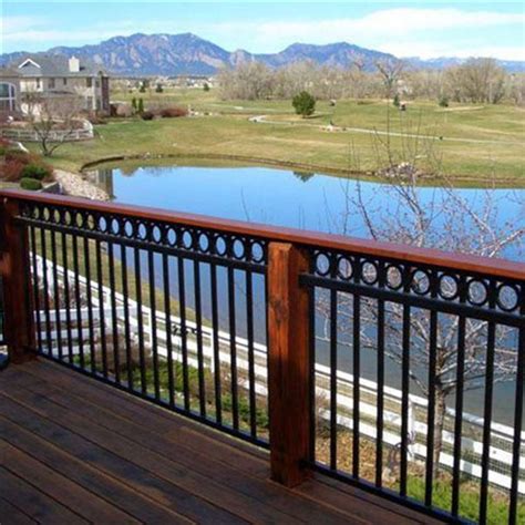 a wooden deck overlooking a lake with mountains in the background