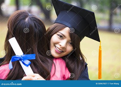 Young Graduate Hugging Her Friend at Graduation Ceremony Stock Image - Image of achievement ...