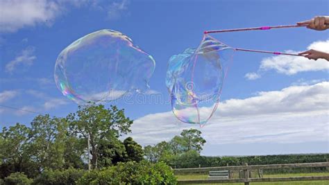 Giant Soap Bubble with Bubble Wand Stock Image - Image of foam, enclosing: 214028393