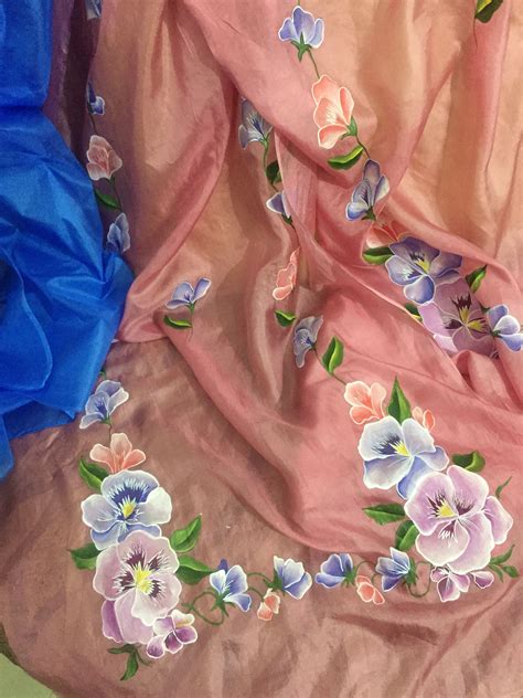 an image of some fabric with flowers on it and one is blue, the other has pink