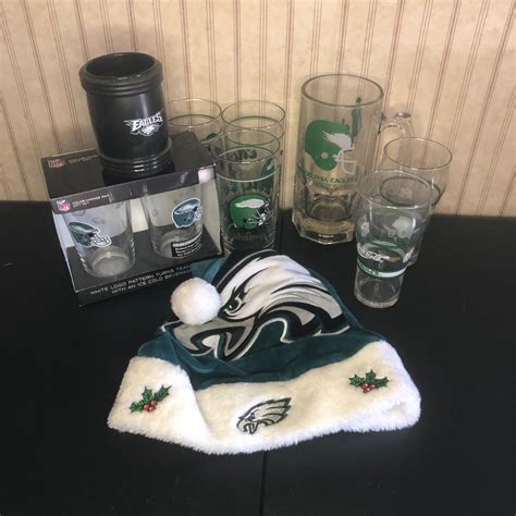 LOT 20M: Eagles Collection - Glasses, Drink Cover, Santa Hat | EstateSales.org