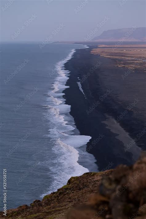 Dyrholaey lighthouse over black sand beach in Iceland Stock Photo | Adobe Stock