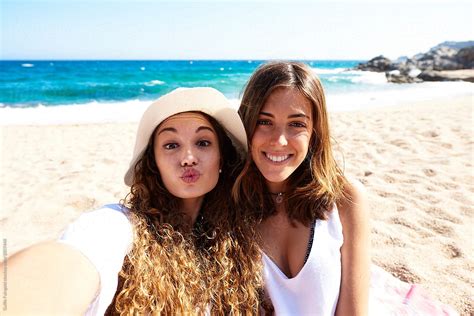 "Two Friends Making Selfie On Beach" by Stocksy Contributor "Guille Faingold" - Stocksy