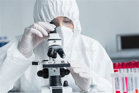 Scientist in Hazmat Suit Using Microscope Stock Photo - Image of blood, virus: 252328910