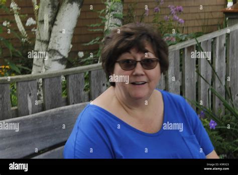 woman sitting on a park bench Stock Photo - Alamy