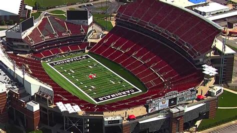 'Heisman Cardinal' logo laid down on Louisville's football field