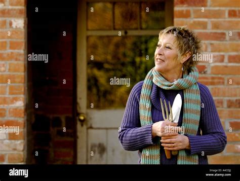 TV gardener Carol Klein relaxing in garden at home in Devon Stock Photo ...