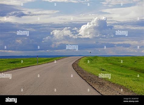 Empty road and rain clouds forming over the Gobi desert, rain shadow ...