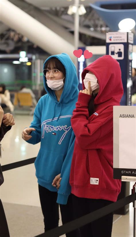 two people wearing face masks in an airport