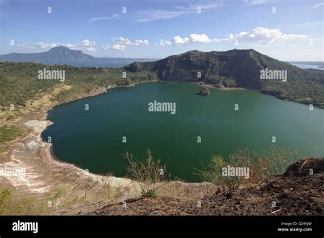 Crater lake in the main crater of Taal Volcano, with Lake Taal in the background. Luzon ...