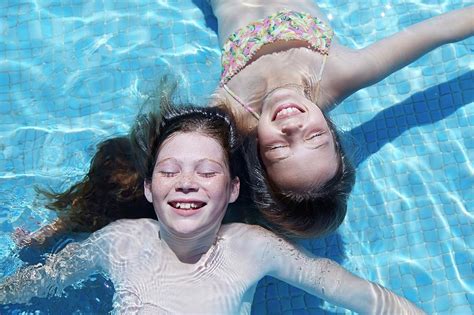 Two Girls Floating In Water Photograph by Ruth Jenkinson - Pixels