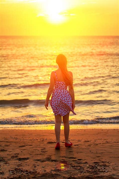 Silhouette at Sunset Girl on the Beach, Evening Walks on the Coast Stock Photo - Image of orange ...