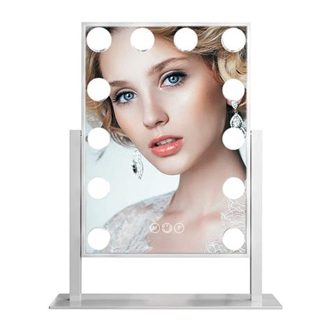 a lighted vanity mirror with lights on it and a woman's face in the reflection