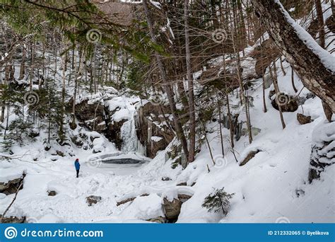 Hikers Near Frozen Kinsman Falls in Franconia Notch State Park during ...