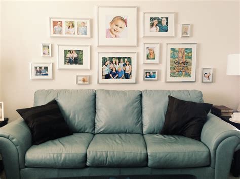 a living room filled with furniture and framed pictures on the wall ...