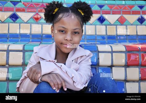 Young black girl closed mouth smile Stock Photo - Alamy