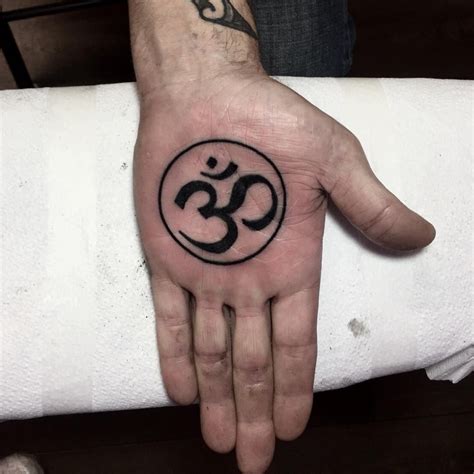 Black Om symbol tattoo on the left palm | Circle tattoo, Tattoos, Om symbol tattoo