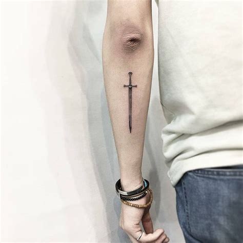 Little black sword tattoo on the back of the left forearm #Tattoosonback | Sword tattoo, Tricep ...