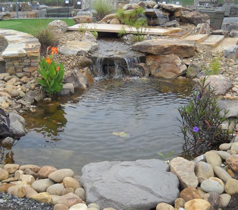 Water feature includes pond, boulders and natural stone. Fountains ...