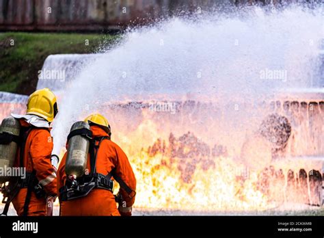 Firefighter using Chemical foam fire extinguisher to fighting with the ...