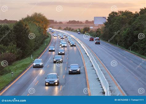 Cars on Highway Road at Sunset Stock Photo - Image of driving, light ...