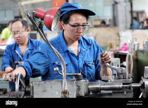 Chinese workers manufacture steel products at a factory in Qiqihar city, northeast Chinas ...