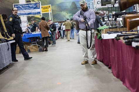 Showmasters Gun Show | An officer looks on as a customer han… | Flickr