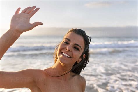 Spain, Asturias, beautiful young woman on the beach at sunset stock photo