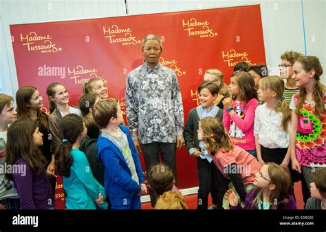 Berlin, Germany. 08th May, 2014. Pupils of the Nelson Mandela School look at the wax figure of ...