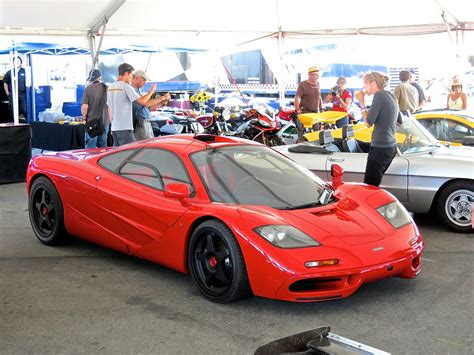 A bright red McLaren F1 in the paddock at Laguna Seca | Mind Over Motor