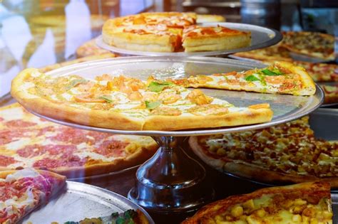 Premium Photo | Pizza resting on a pizzeria counter with sunlight ...