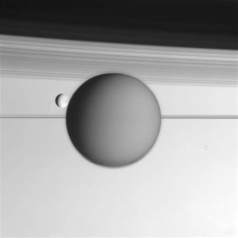 Raw Cassini image of Titan and Enceladus backdropped by Saturn's rings ...