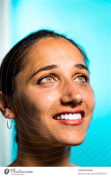 Face of Young Indian Woman Smiling on Blue Background - a Royalty Free Stock Photo from Photocase