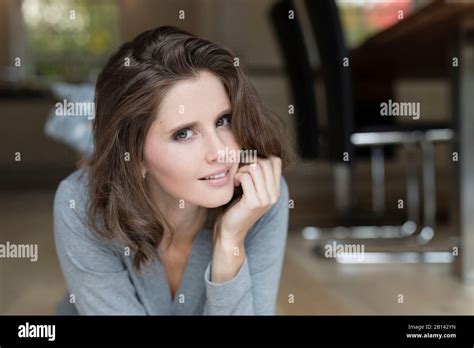 Young woman on floor in the dining room Stock Photo - Alamy