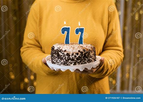 Woman Holding a Festive Cake with Number 77 Candles while Celebrating ...