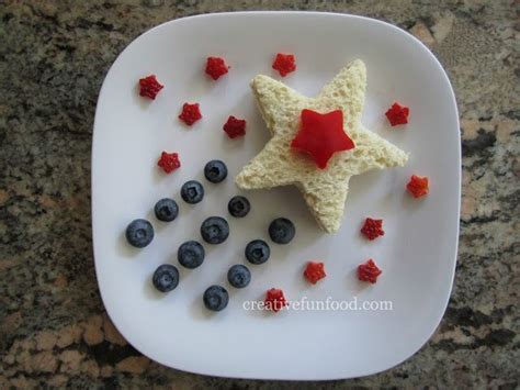 a white plate topped with blueberries and a star shaped cake