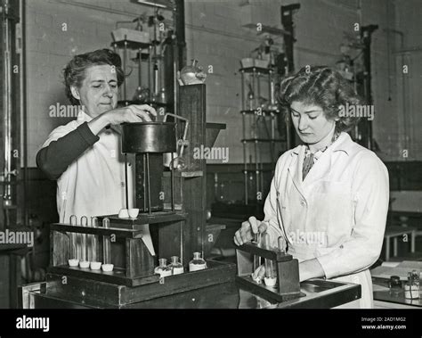 Mining safety lamp inspection. Laboratory workers handling and inspecting a mining safety lamp ...