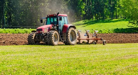 Farmer In Tractor Plowing Field Stock Photo - Image of dairy, farm ...