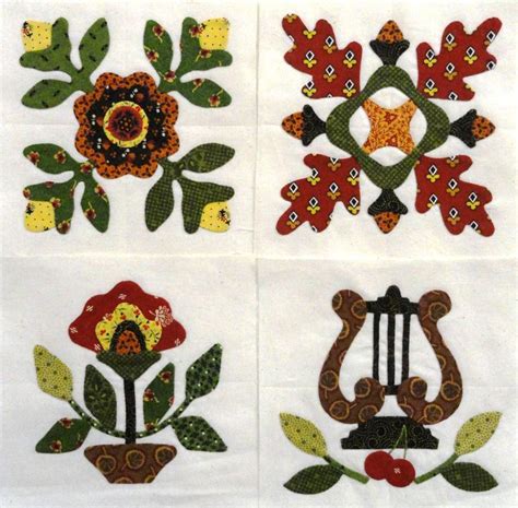 four pieces of embroidered fabric with flowers on them