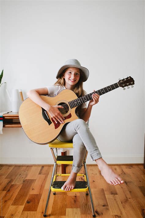 "Young Girl Playing Guitar" by Stocksy Contributor "Erin Drago" - Stocksy