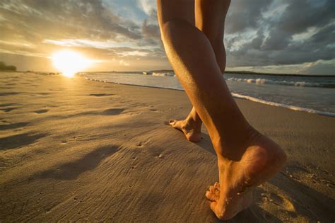 Barefoot On Beach Walking Towards Sunlight Stock Photo - Download Image ...