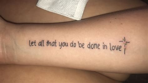 two people with tattoos that say let all that you do be done in love on their arm