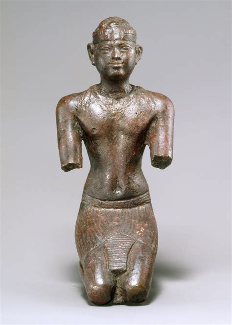 an old bronze figurine sitting on top of a table