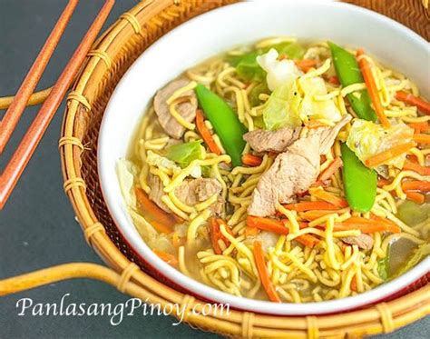 a bowl filled with noodles, meat and veggies