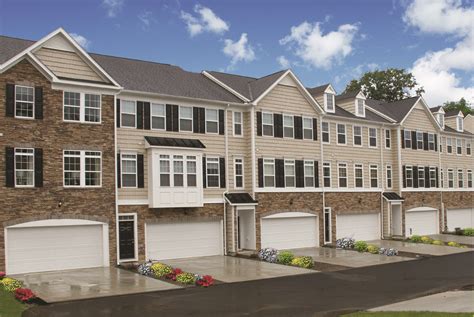 The beautiful Windsor townhomes with stone and siding fronts, bay ...