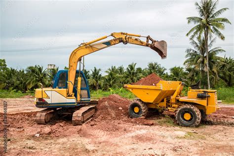 Building Machines: Digger loading trucks with soil. Excavator loading ...