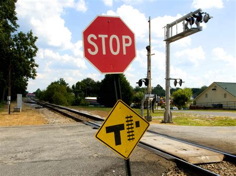 Free picture: two, traffic, signs, indicating, intersection, roadway, railway