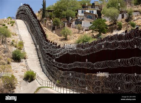 Daytime view of the fortified USA Mexico border wall as it runs through ...